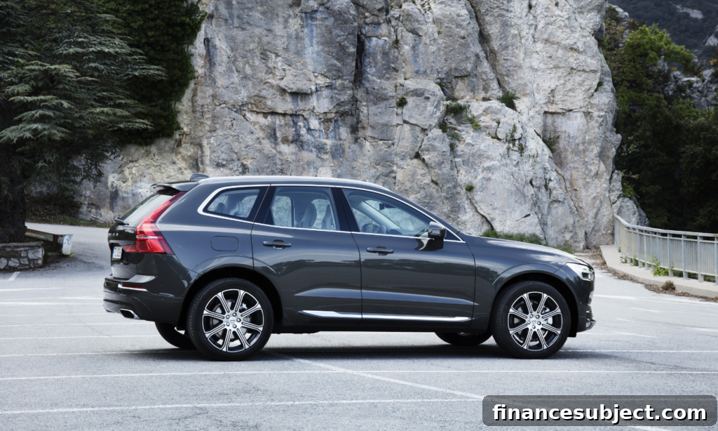 A black Volvo XC60 parked besides a rockface