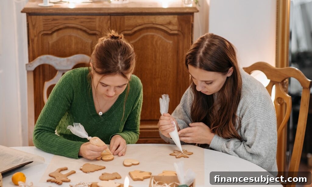 Two teenage girls add icing to gingerbread cookies