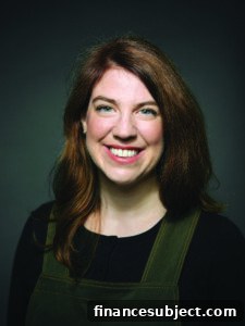 Author and financial planner Shannon Lee Simmons smiles for the camera against a dark background.