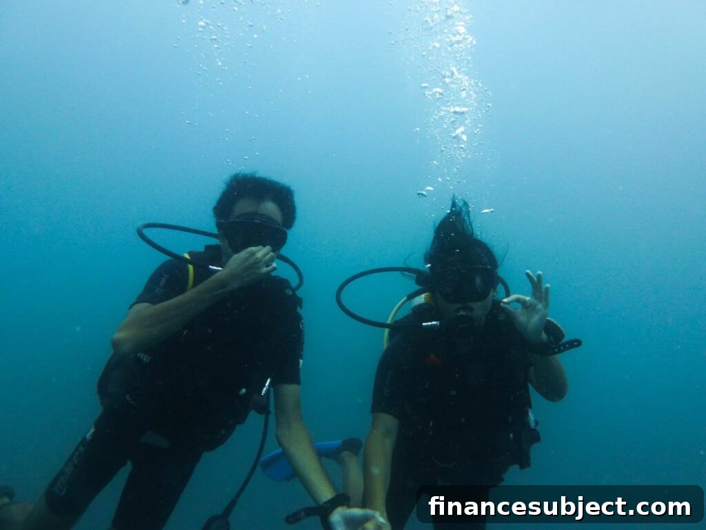 A man and a woman underwater in scuba gear
