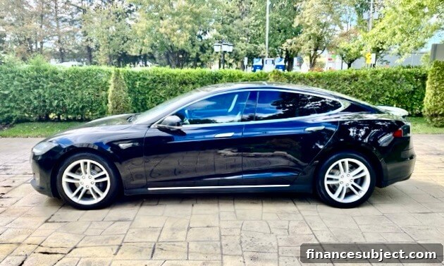 Side view of a Tesla Model S sedan on a driveway