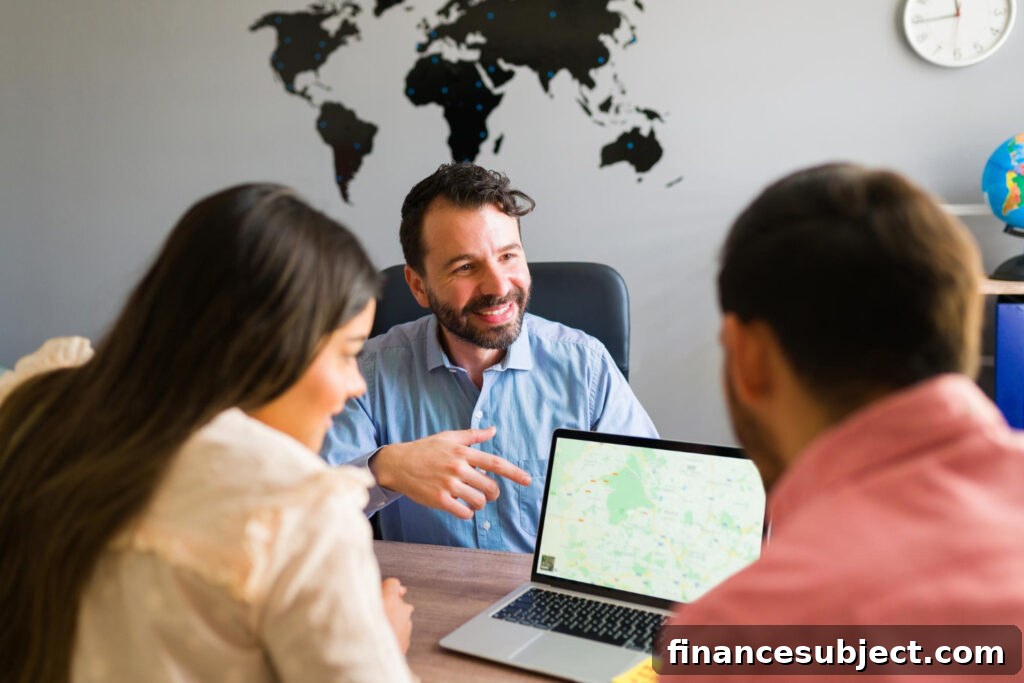 A travel agent smiles as he shows a map to a young man and woman
