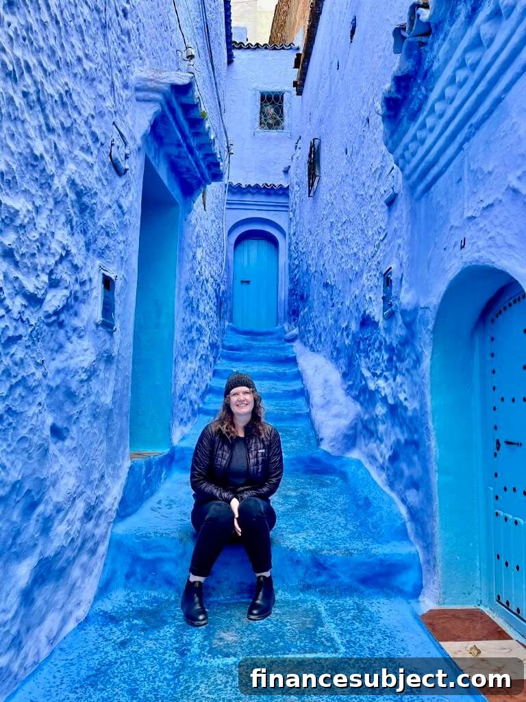 Meghan Bailey sits on a blue staircase in Morocco
