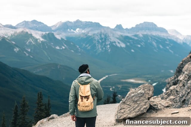 A man on a hike in the mountains enjoys the active lifestyle in Alberta.