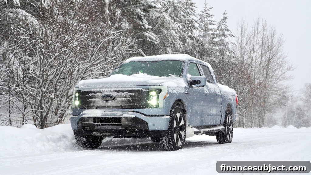 A blue Ford F-150 Lightning on a snowy road