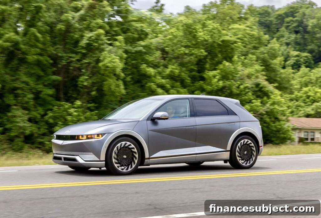 A grey Ioniq 5 drives down a street