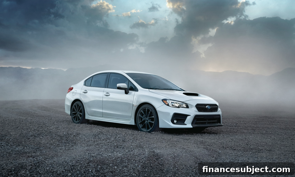 A white Subaru WRX sports car on a gravel road