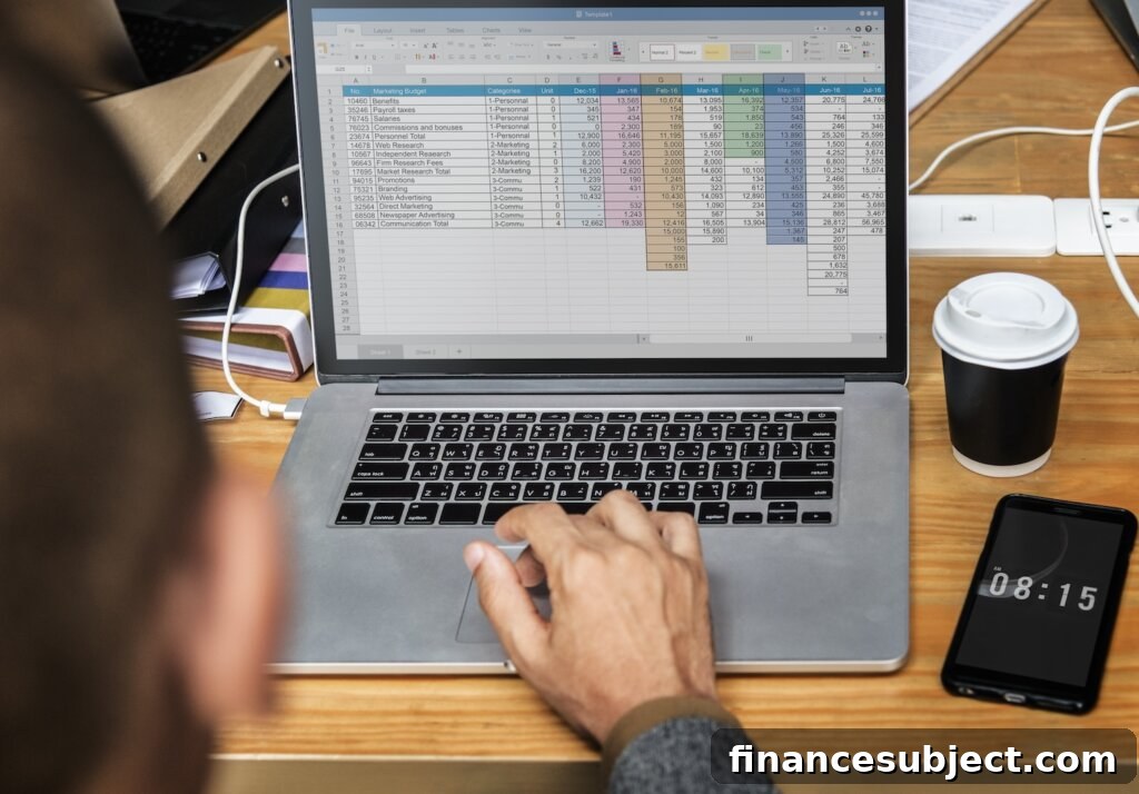 self-employed person tabulates income on laptop computer